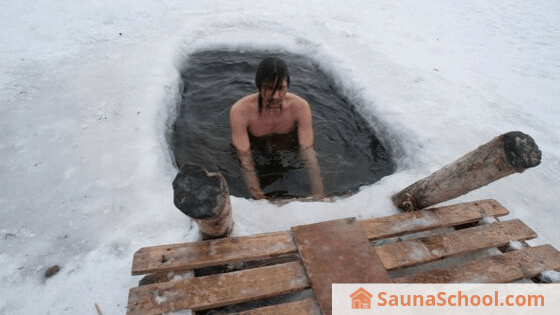 Taking an ice water plunge to cool off after a Finnish sauna session