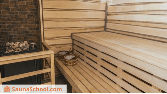 Inside Finnish Sauna with stove and wood benches